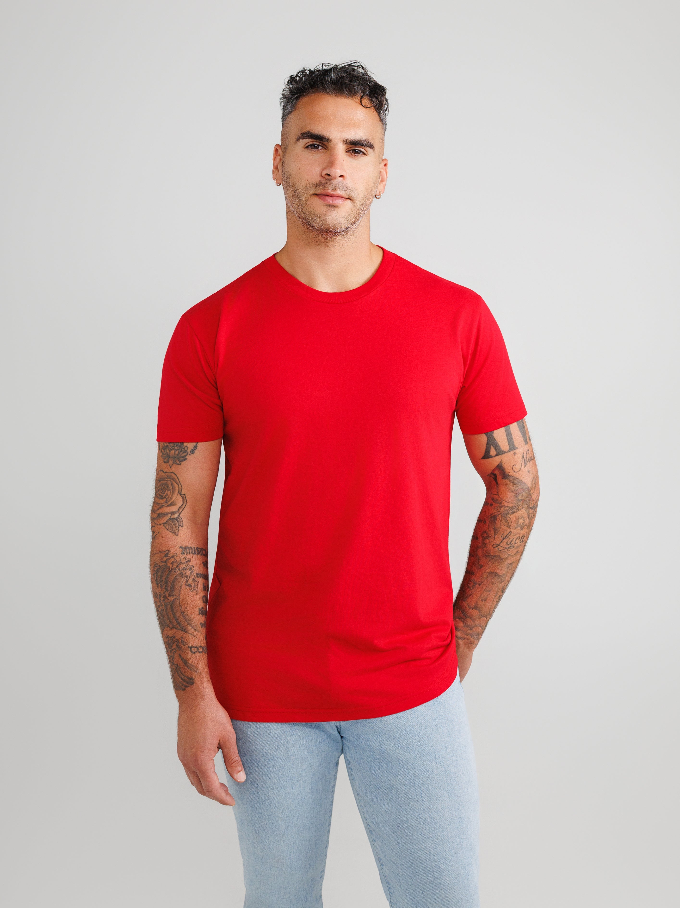 Man wearing a red t-shirt against a gray background